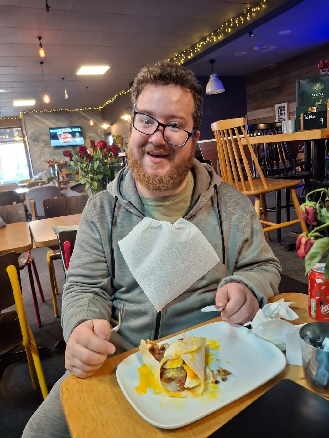 A customer enjoying a full English breakfast at Revive Cafe in Norwich